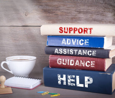 Support concept. Stack of books on wooden desk Support concept. Stack of books on wooden desk